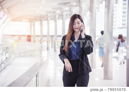 Business woman using smartphone shopping online, call, texting message internet technology lifestyle. Asian woman using cellphone walking on city street. Smart phone smart confident woman modern city Business woman using smartphone shopping online, call, texting message internet technology lifestyle. Asian woman using cellphone walking on city street. Smart phone smart confident woman modern city 79955070