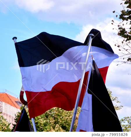 Flag of the former German Empire in the colors black white red blows in the wind 79955826