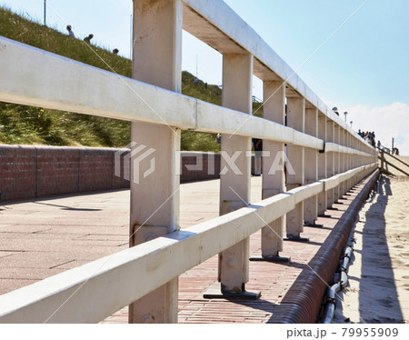 White wooden balustrade on the beach promenade of Westerland, Sylt, Germany 79955909