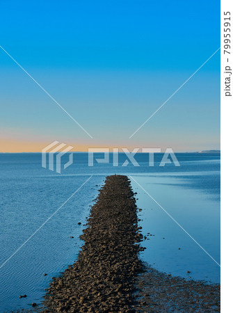 Breakwater made of gravel stones in the blue North Sea against a blue sky, abstract, calm, meditative Breakwater made of gravel stones in the blue North Sea against a blue sky, abstract, calm, meditative 79955915