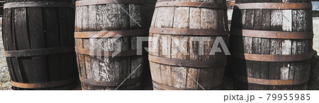 Old dirty weathered wooden barrels with rusty barrel hoops 79955985