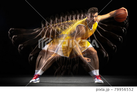 Young caucasian basketball player in motion and action isolated on dark background with stroboscope effect. Concept of healthy lifestyle, professional sport, hobby. Young caucasian basketball player in motion and action isolated on dark background with stroboscope effect. Concept of healthy lifestyle, professional sport, hobby. 79956552