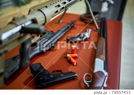 Rifles and pistols on counter in gun store 79957453