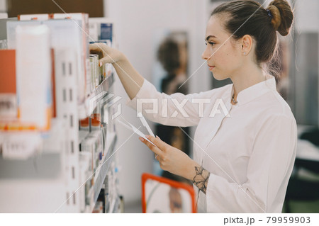 Woman pharmacist checking medicine in pharmacy Woman pharmacist checking medicine in pharmacy 79959903
