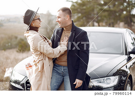 Beautiful couple spend time on a autumn field Beautiful couple spend time on a autumn field 79960114