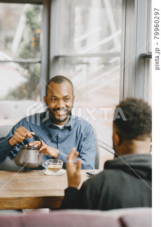 Two colleagues having a conversation with a cup of tea during the break Two colleagues having a conversation with a cup of tea during the break 79960297