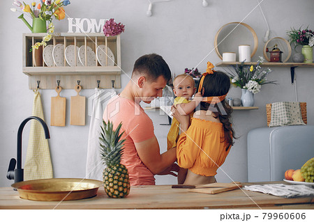 Beautiful family prepare food in a kitchen Beautiful family prepare food in a kitchen 79960606