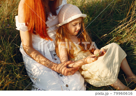 Mother with daughter playing in a summer field 79960616