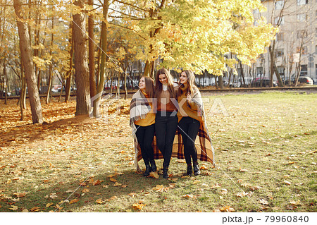 Elegant and stylish girls in a autumn park 79960840