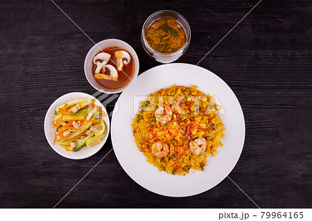 fried rice with peas and seafood, green tea, sauce and salad fried rice with peas and seafood, green tea, sauce and salad 79964165