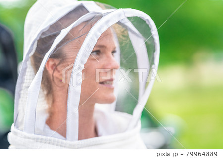 woman beekeeper in protective suit in beekeeping woman beekeeper in protective suit in beekeeping 79964889