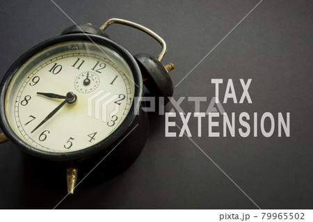 Old alarm clock and tax extension words. Old alarm clock and tax extension words. 79965502