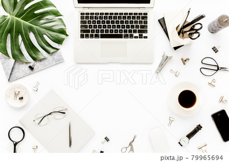 Home office workspace mockup with laptop, tropical leaves Monstera, clipboard, notebook and accessories on white background. Flat lay, top view 79965694