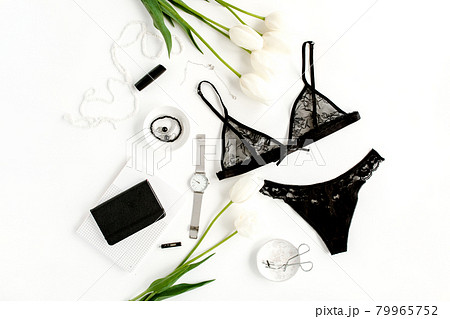 Flat lay stylish, sexy, black lingerie, accessories on a white background. Top view. Flat lay stylish, sexy, black lingerie, accessories on a white background. Top view. 79965752