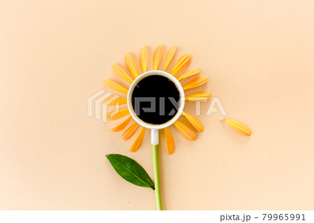 Cup of coffee and flower petals on a beige background. Flat lay, top view Cup of coffee and flower petals on a beige background. Flat lay, top view 79965991