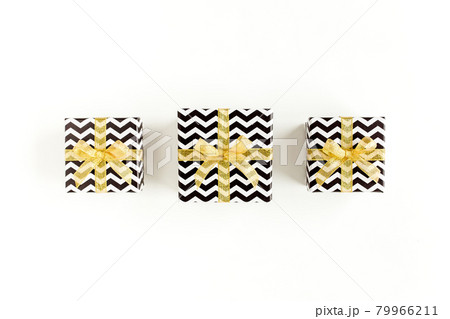 Gift or present boxes and stars confetti on a white background. Colorful celebration, birthday. Christmas or New Year pattern. Flat lay, top view Gift or present boxes and stars confetti on a white background. Colorful celebration, birthday. Christmas or New Year pattern. Flat lay, top view 79966211
