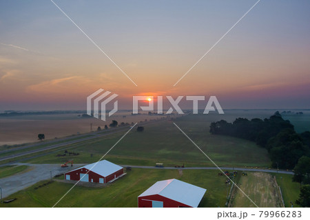 Beautiful misty village landscape meadow with fog early morning sunrise 79966283