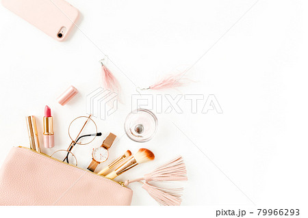 Flat lay composition with pink cosmetic bag with cosmetic makeup products, isolated on white background. Flat lay, top view. Flat lay composition with pink cosmetic bag with cosmetic makeup products, isolated on white background. Flat lay, top view. 79966293