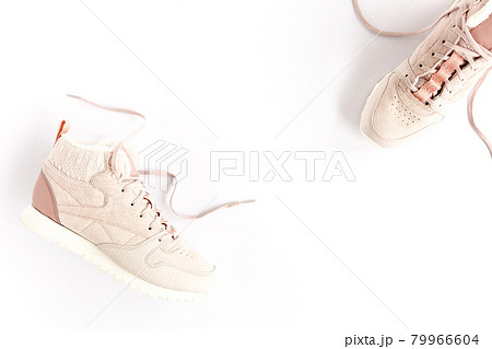 Pink female sneakers on white background. Flat lay, top view minimal background. Fashion blog or magazine concept. 79966604