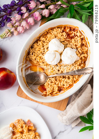 Homemade nectarine crumble with vanilla ice cream Homemade nectarine crumble with vanilla ice cream 79968219
