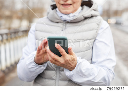 Mature Woman Holding Smartphone Mature Woman Holding Smartphone 79969275