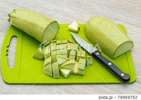 Zucchini sliced on a green cutting board. Fresh, ripe, tasty, natural vegetable 79969702