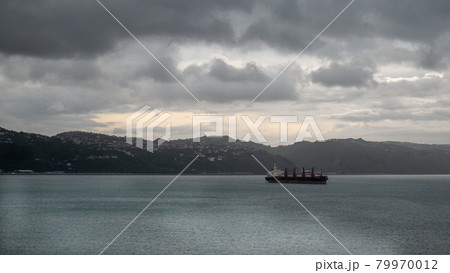 Transport ship sailing on ocean during overcast day, Shot taken on ferry heading from North to South Island, New Zealand Transport ship sailing on ocean during overcast day, Shot taken on ferry heading from North to South Island, New Zealand 79970012