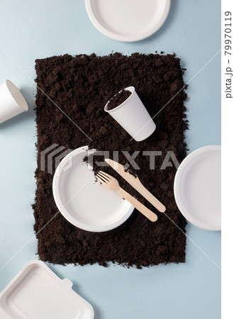 Single-use tableware dinnerware popular non-plastic alternatives on ground on blue flat lay composition, top view. Compostable or biodegradable dinnerware concept Single-use tableware dinnerware popular non-plastic alternatives on ground on blue flat lay composition, top view. Compostable or biodegradable dinnerware concept 79970119