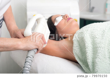 Laser epilation and cosmetology in beauty salon. Cosmetology, spa and hair removal concept. Laser epilation and cosmetology in beauty salon. Cosmetology, spa and hair removal concept. 79970150