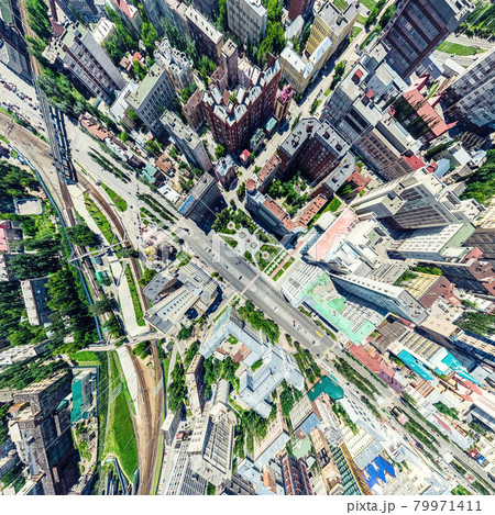 Aerial city view with crossroads and roads, houses, buildings, parks and parking lots. Sunny summer panoramic image Aerial city view with crossroads and roads, houses, buildings, parks and parking lots. Sunny summer panoramic image 79971411