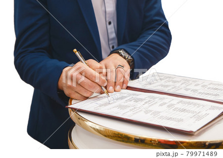 Groom's man's hands put on the signature in the magazine about consent to marriage at the wedding 79971489