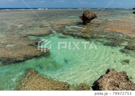 Gorgeous top view at a natural coral reef sea pool, emerald green sea, coastal rocks, blue sky. Iriomote Island, natural world heritage. 79972753