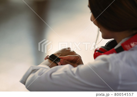 Close up of woman traveler checking time on her smartwatch. 80054557