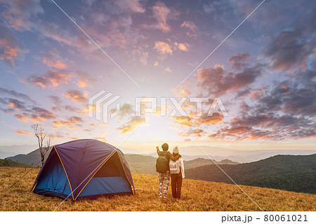 Young couple traveler looking landscape at sunset and camping on mountain, Adventure travel lifestyle concept 80061021