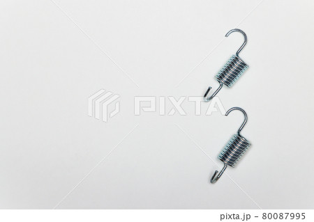 Two short metal springs for repairing the brakes of the machine. 80087995