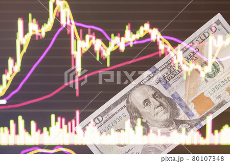 dollars in front of a laptop monitor with a price chart.Forex and trading.A trader trades stocks,bonds and securities or currencies on the Forex market or stock exchange for us dollars.100 dollars. dollars in front of a laptop monitor with a price chart.Forex and trading.A trader trades stocks,bonds and securities or currencies on the Forex market or stock exchange for us dollars.100 dollars. 80107348