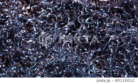 Abstract color background of metal shavings. Processing of ferrous and non-ferrous metals in a factory or plant. Metal background. Colored shavings. Wallpaper or screensaver of colored metallic chips 80110012