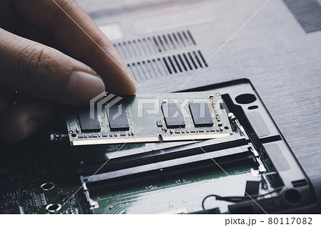 Technician install new RAM (Random-access memory) to memory slot on laptop motherboard 80117082