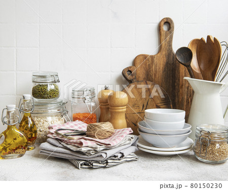 Kitchen utensils, tools and dishware on on the background white tile wall. Kitchen utensils, tools and dishware on on the background white tile wall. 80150230
