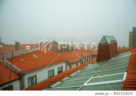 Tiles in a roof with skylight in the morning mist 80232924