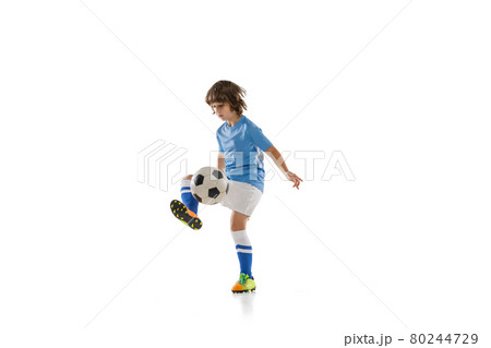 One preschool boy, football soccer player in action, motion training isolated on white studio background. Concept of sport, game, hobby One preschool boy, football soccer player in action, motion training isolated on white studio background. Concept of sport, game, hobby 80244729