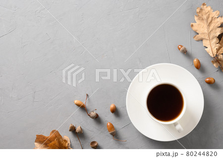 Acorn coffee with oak leaves on gray table. View from above. Acorn coffee with oak leaves on gray table. View from above. 80244820