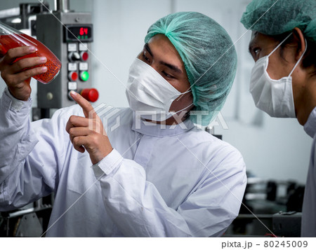 Nutritionists checking the quality of the herbal drinks check the quality of drink basil seed produces on a conveyer belt before distribution to market business. 80245009