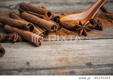 Cinnamon sticks on wooden background. Cinnamon sticks on wooden background. 80245264
