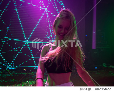 Portrait of beautiful DJ girl standing in the front of the decks. Party and holiday style.. Portrait of beautiful DJ girl standing in the front of the decks. Party and holiday style.. 80245622