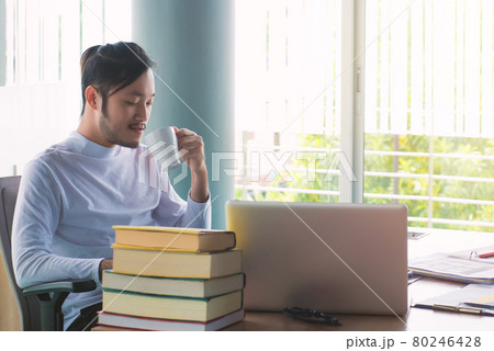 Business man working with laptop computer and documents on his desk at office 80246428