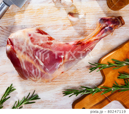 Raw leg of baby goat with ingredients for cooking Raw leg of baby goat with ingredients for cooking 80247119
