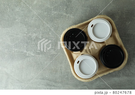 Cup holder with coffee cups on gray textured background Cup holder with coffee cups on gray textured background 80247678