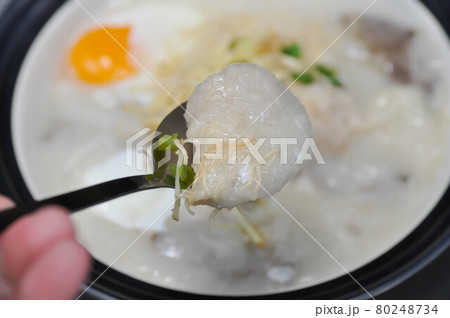 rice gruel, rice porridge or congee with pork and egg or eating rice gruel 80248734