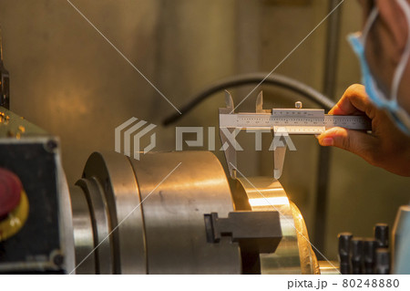 The operator measure thickness of turning brass material part by vernier caliper . The operator measure thickness of turning brass material part by vernier caliper . 80248880